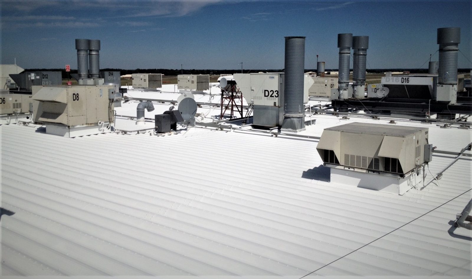 Fluid-applied membrane over a structural deck surface